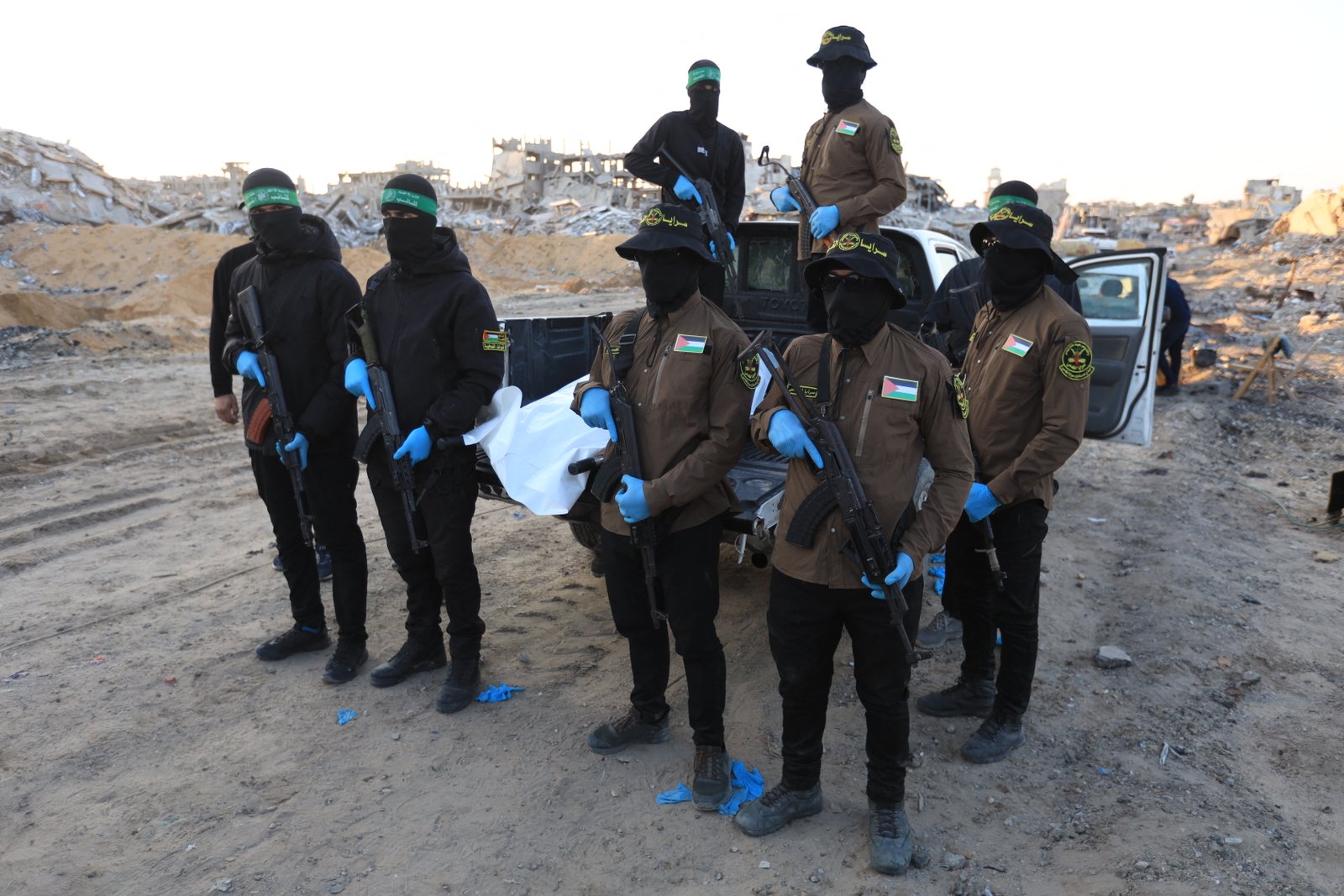 Islamic Jihad and Hamas militants transporting a body bag in northern Gaza