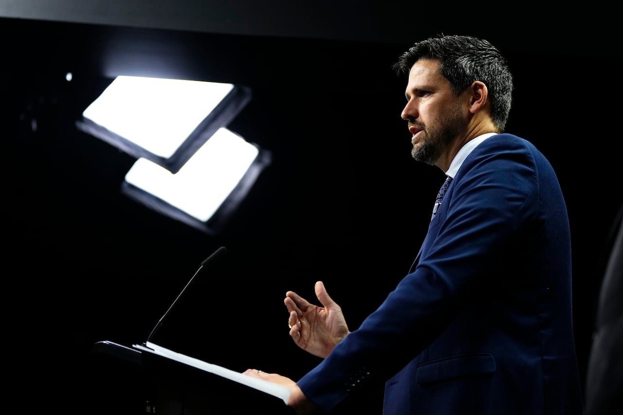 Justice Minister speaking at podium