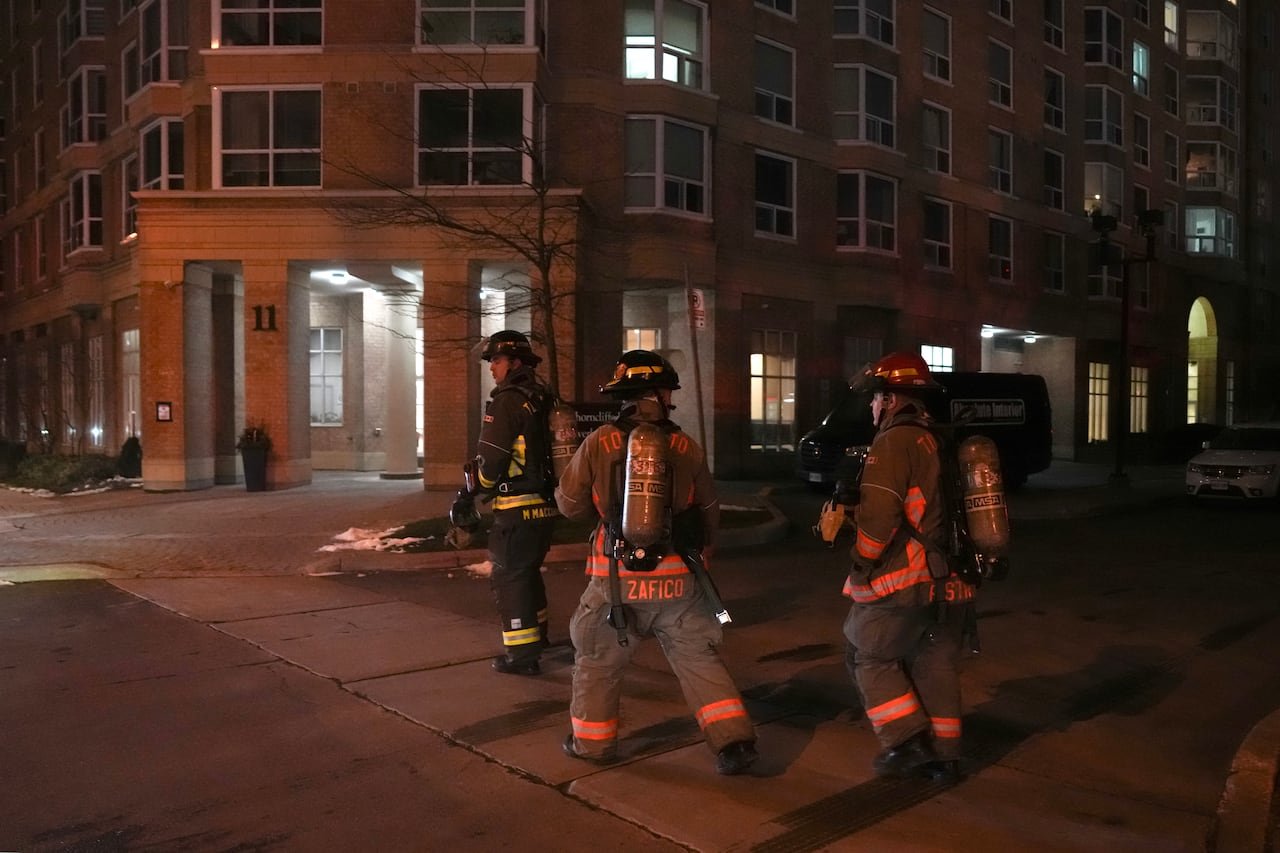 Firefighters approaching apartment entrance