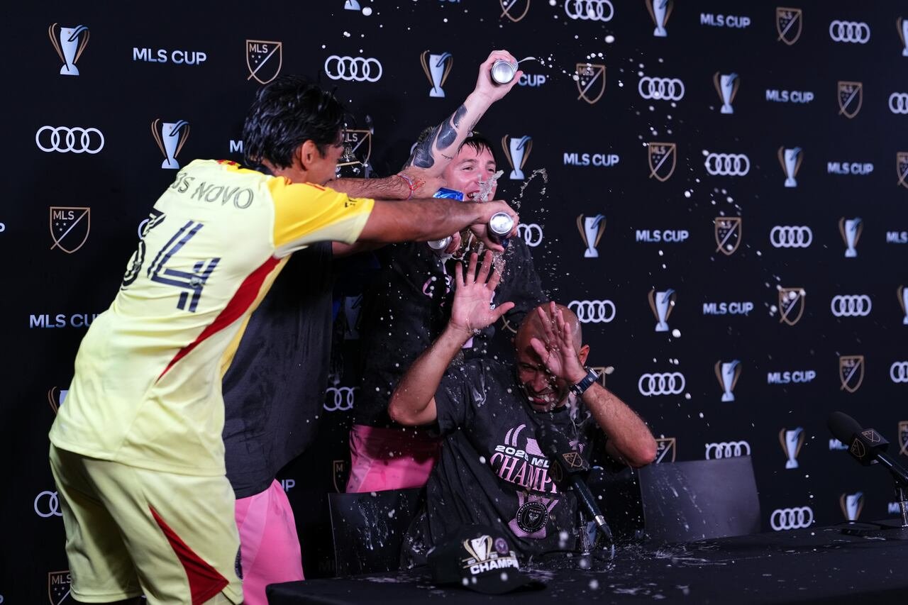Miami players dousing coach Javier Mascherano with celebratory drinks after victory remarks.
