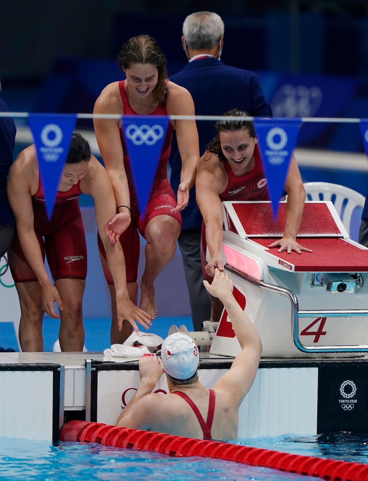Oleksiak celebrates bronze medal win alongside teammates Maggie Mac Neil , Sydney Pickrem , Kylie Masse.