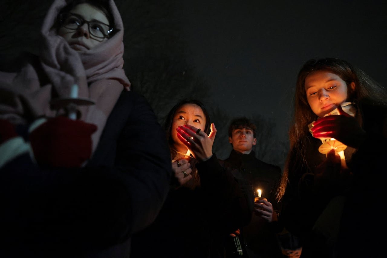 people holding candles during night vigil