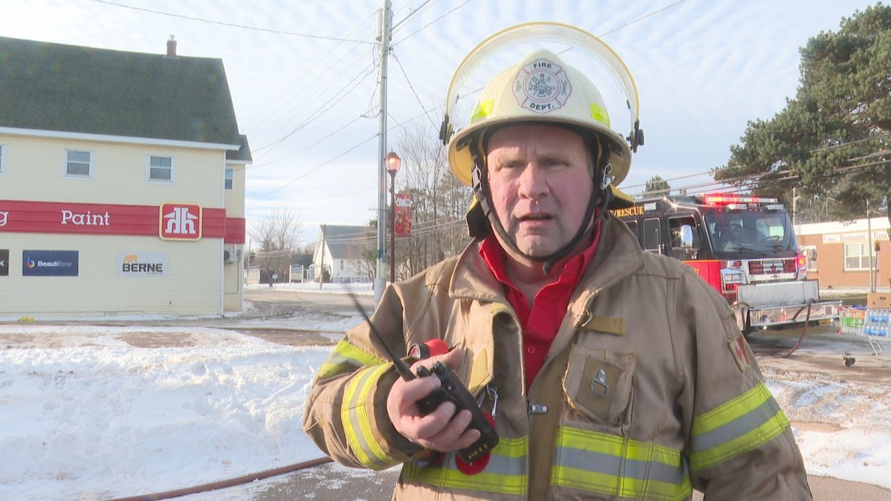 Firefighter standing beside fire truck during response