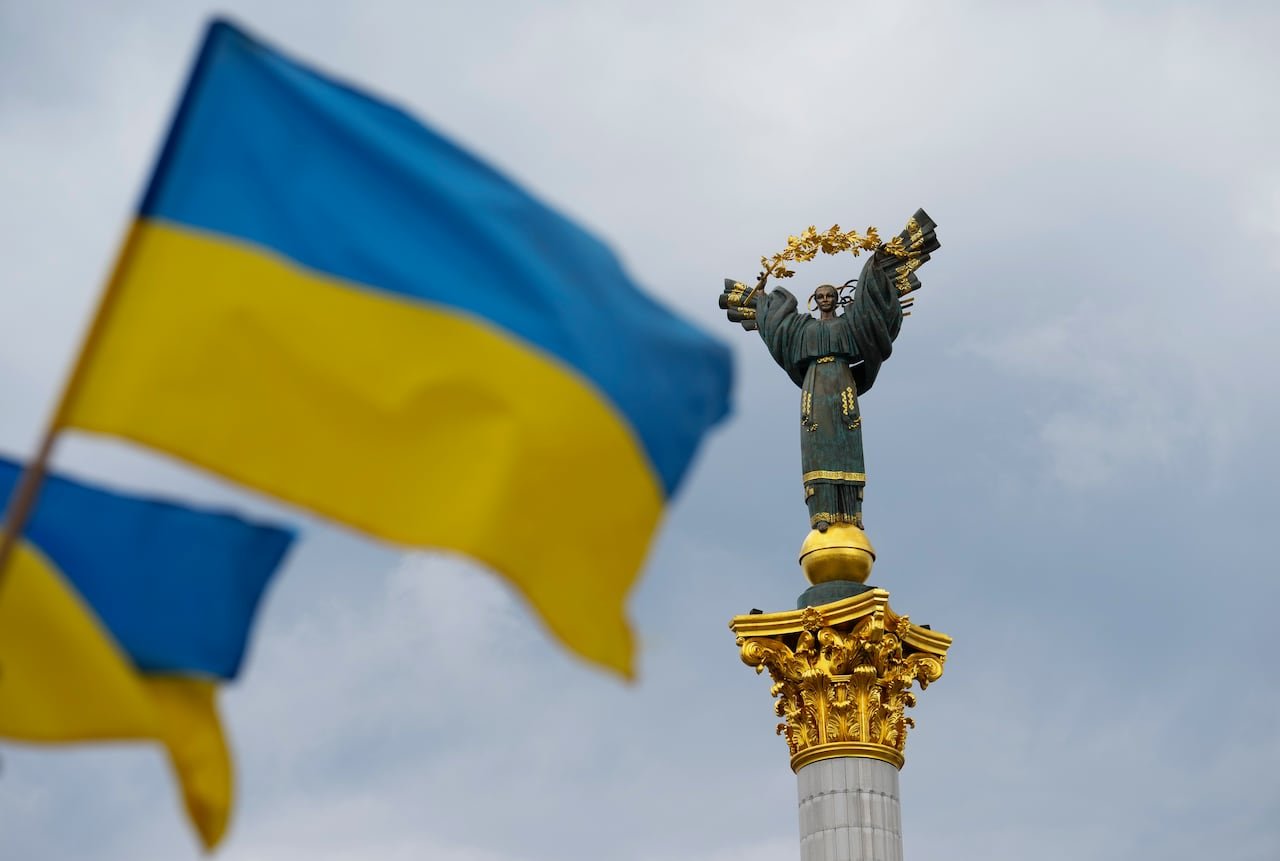 Ukrainian flag waving near monument