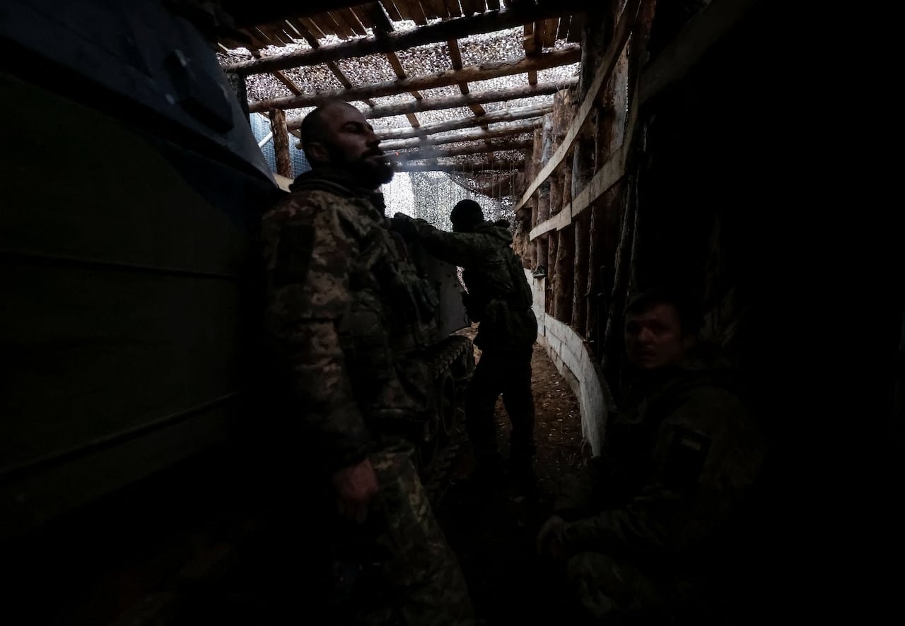 Ukrainian soldiers positioned inside frontline trenches