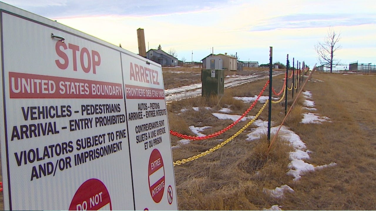Warning signs marking restricted zones at Canada-U.S. border near Coutts