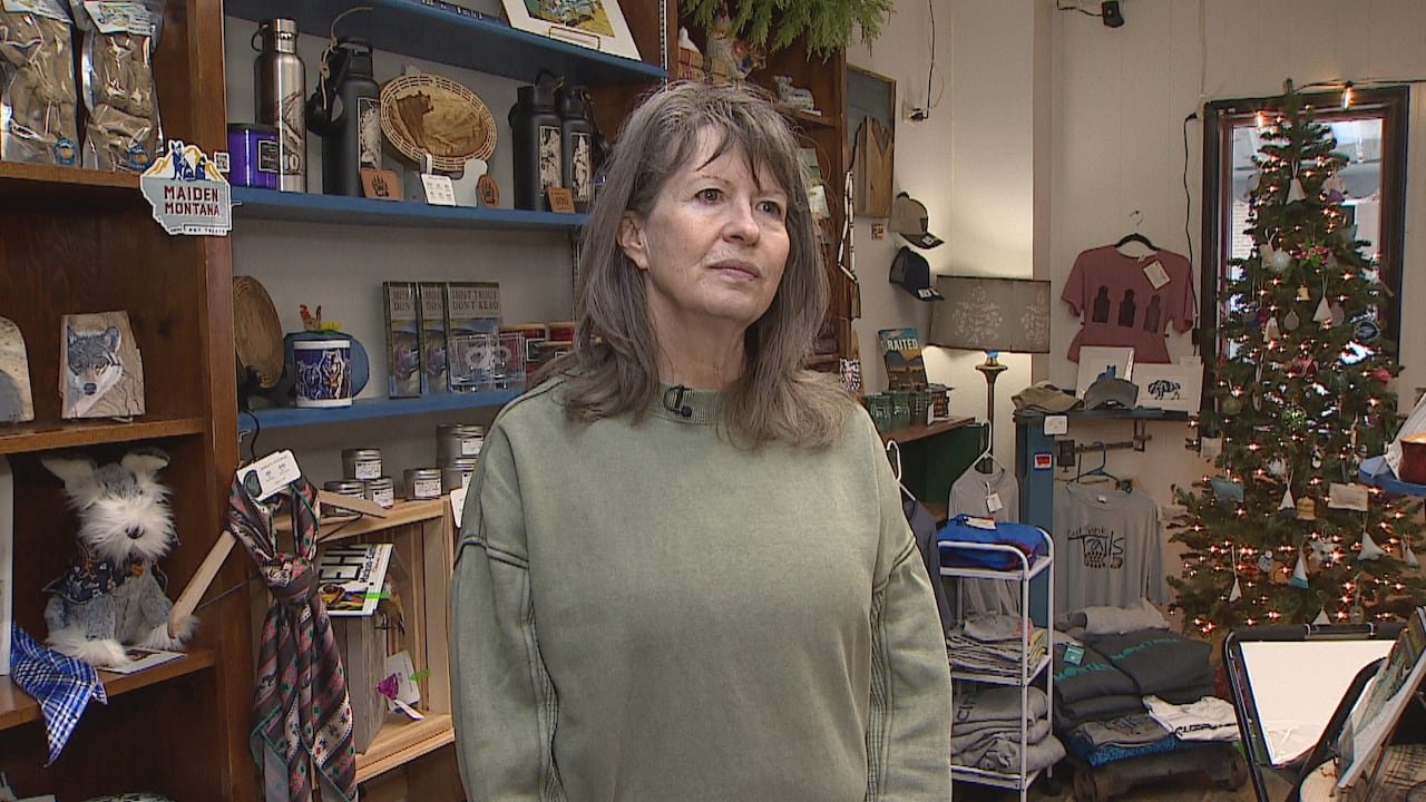 Gift shop owner standing inside store.