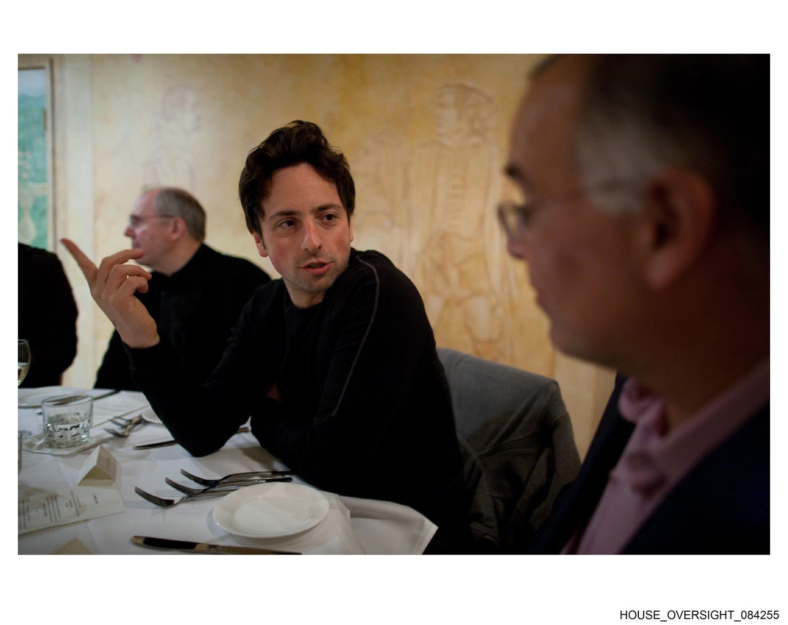 Sergey Brin talking with David Brooks at a gathering attended by Jeffrey Epstein