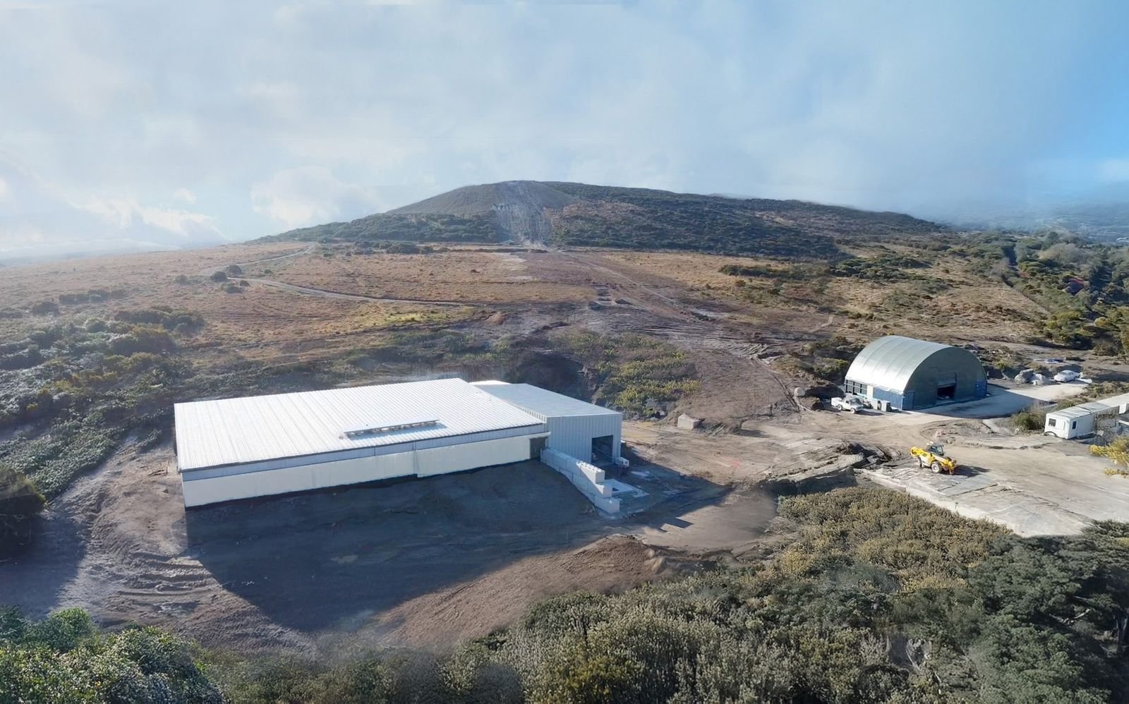 Aerial view showing mountainous terrain with reservoirs connected by pipelines