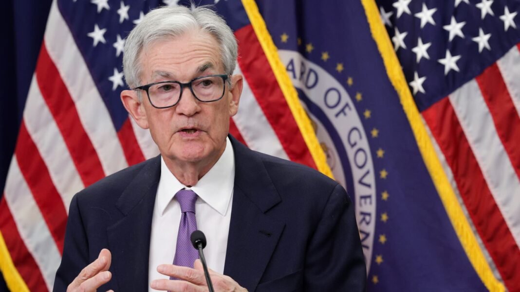 Fed holds key interest rate steady as economic view improves
