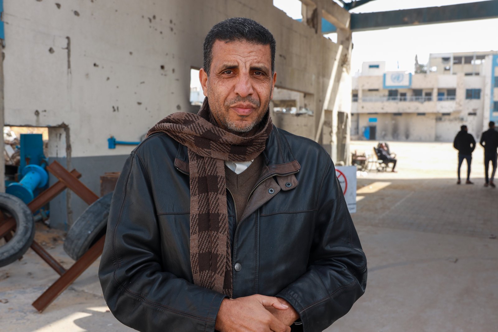 Dr Mustafa Al-Ghoul leading protests against cuts at partially damaged headquarters