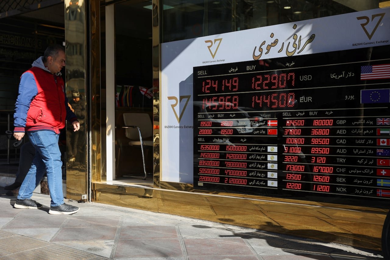Currency exchange rates displayed on a sign amid falling Iranian Rial value