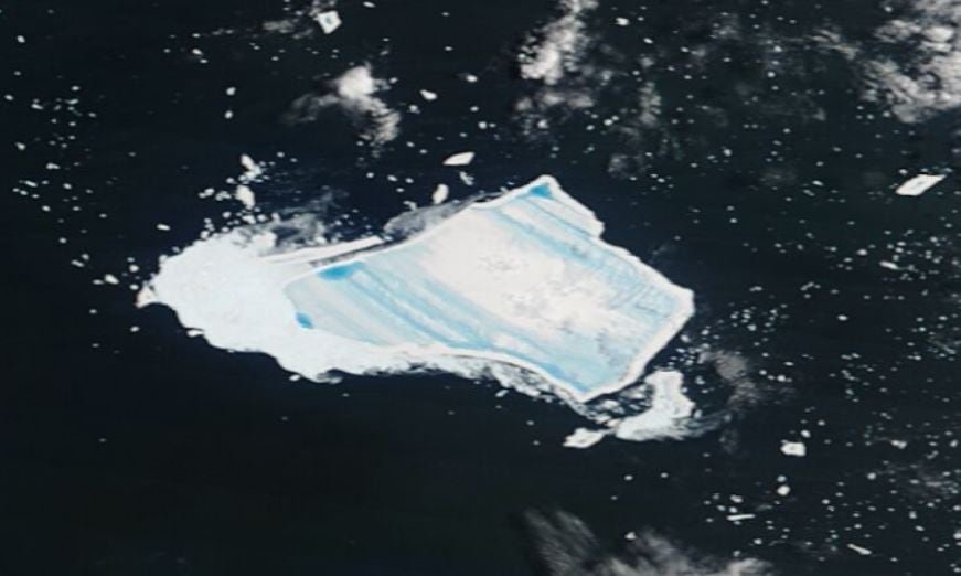 Satellite image showing flat iceberg with blue stripes floating on dark water