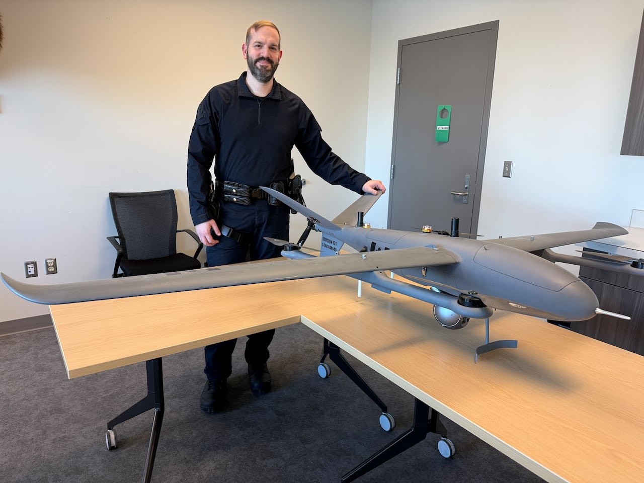 RCMP officer beside large fixed-wing Sky fury drone