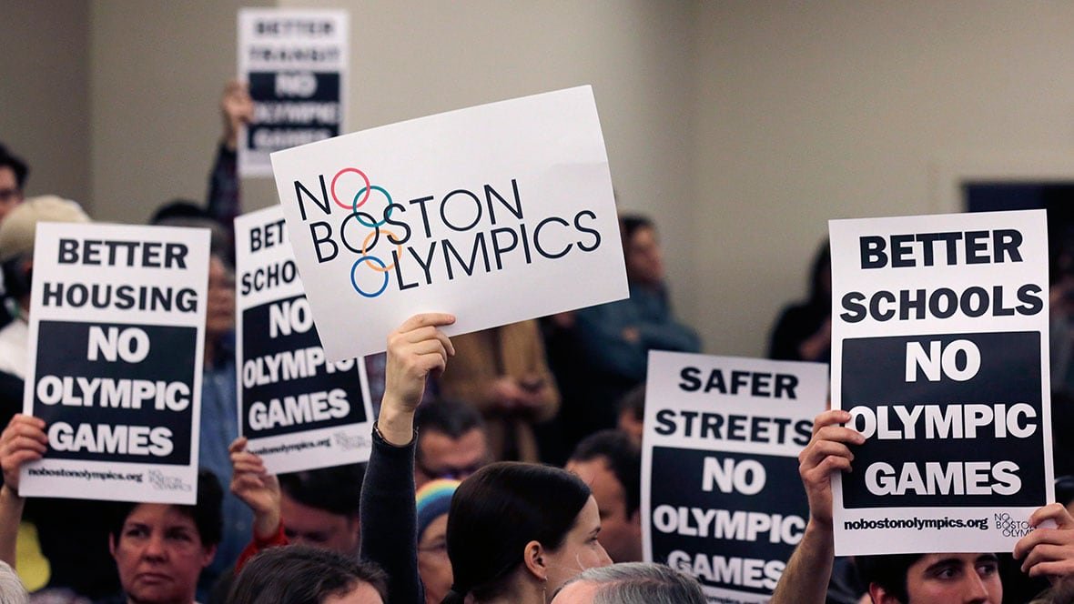Protesters holding signs opposing Boston's Olympic bid