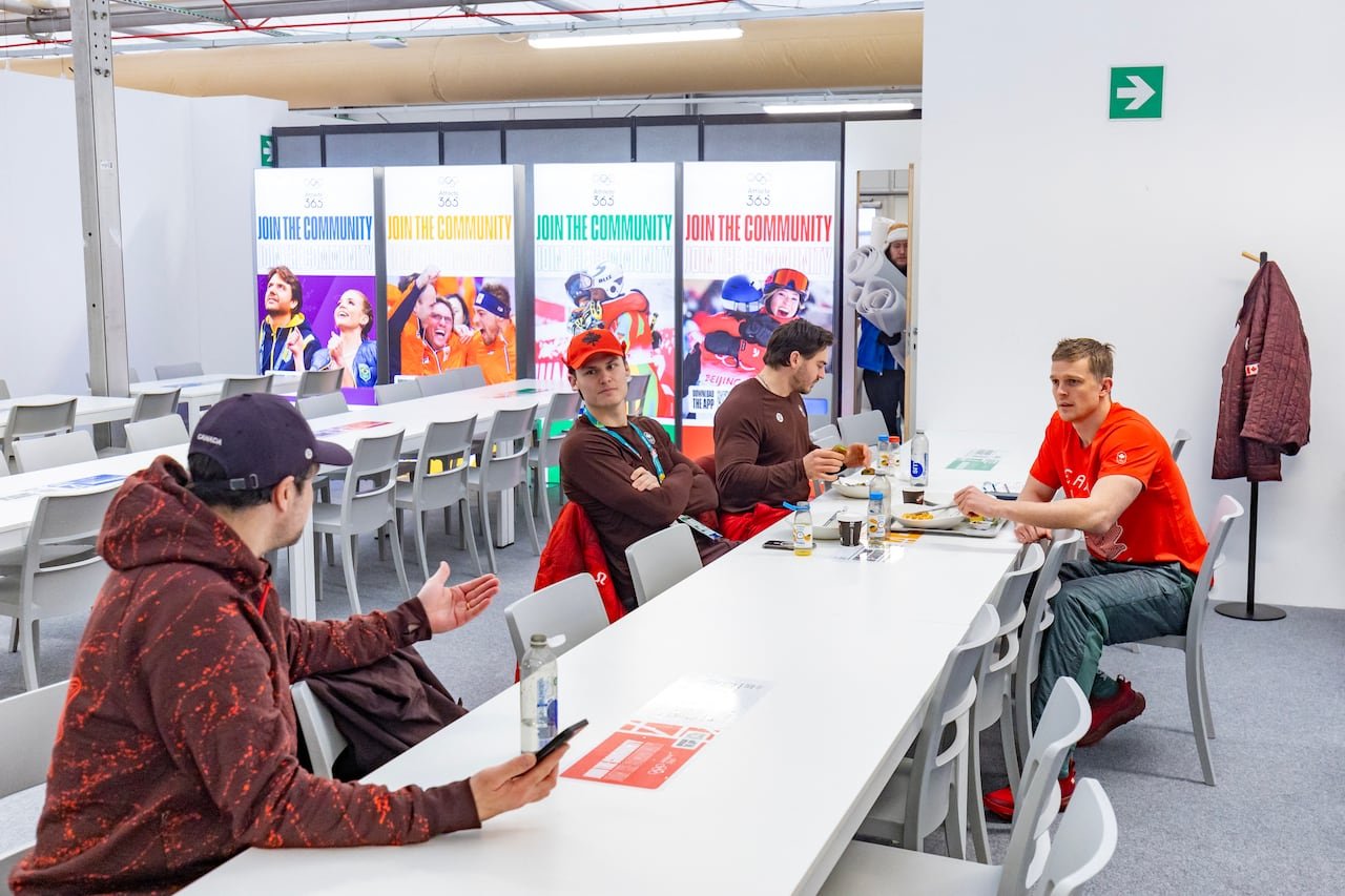 Team Canada members practicing careful hygiene at Olympic Village dining hall