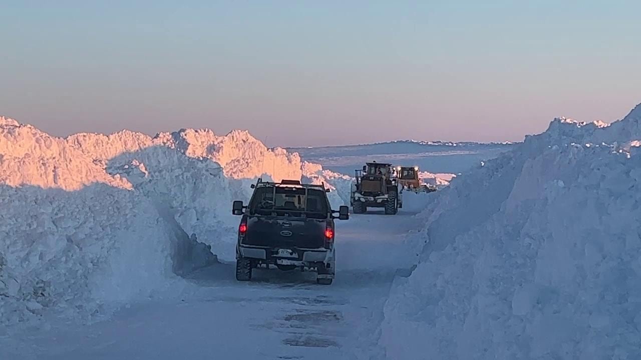 Snow-lined stretch of northern highway with visible frost heave damage