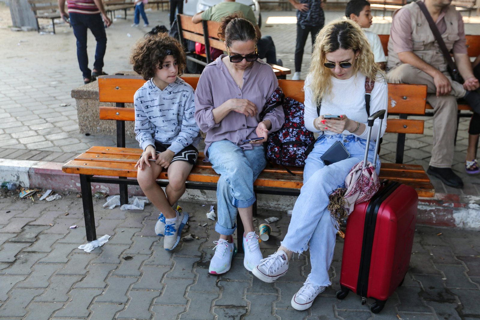 Foreign nationals waiting at Rafah border crossing between Gaza and Egypt