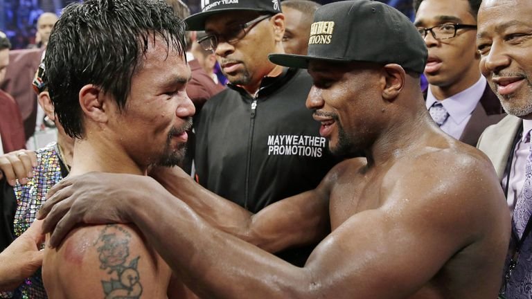Manny Pacquiao and Floyd Mayweather Jr. embracing after their welterweight title fight