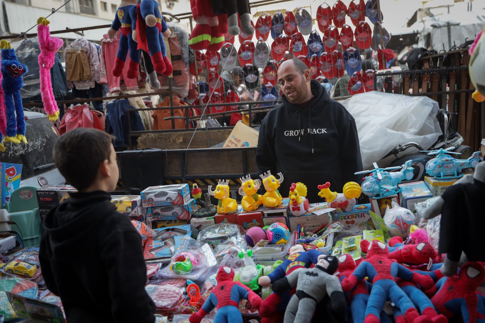 Toy seller arranging scarce inventory