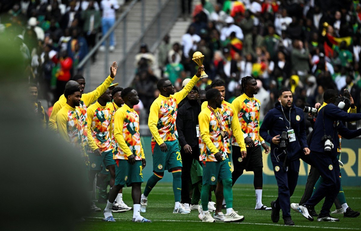 Senegal players parade with AFCON trophy during friendly match
