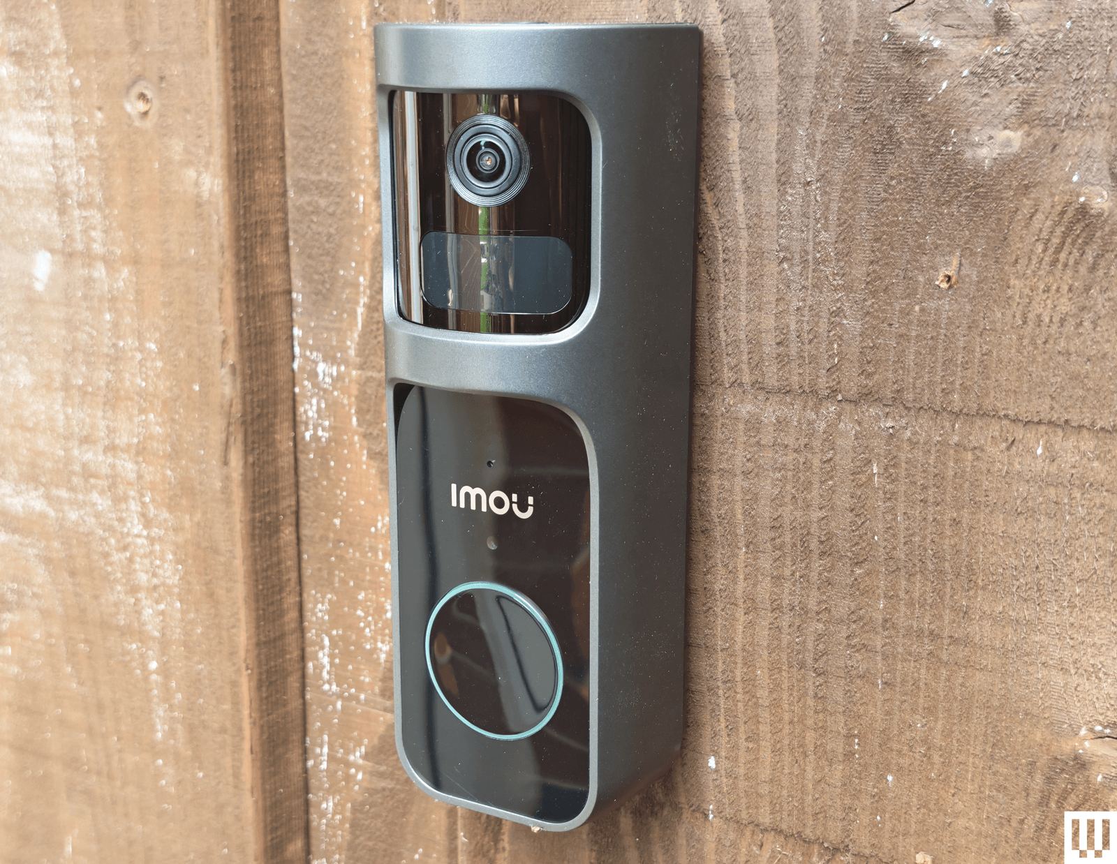 Imou black rectangular motorized lens rotating video doorbel attached outside brick wall