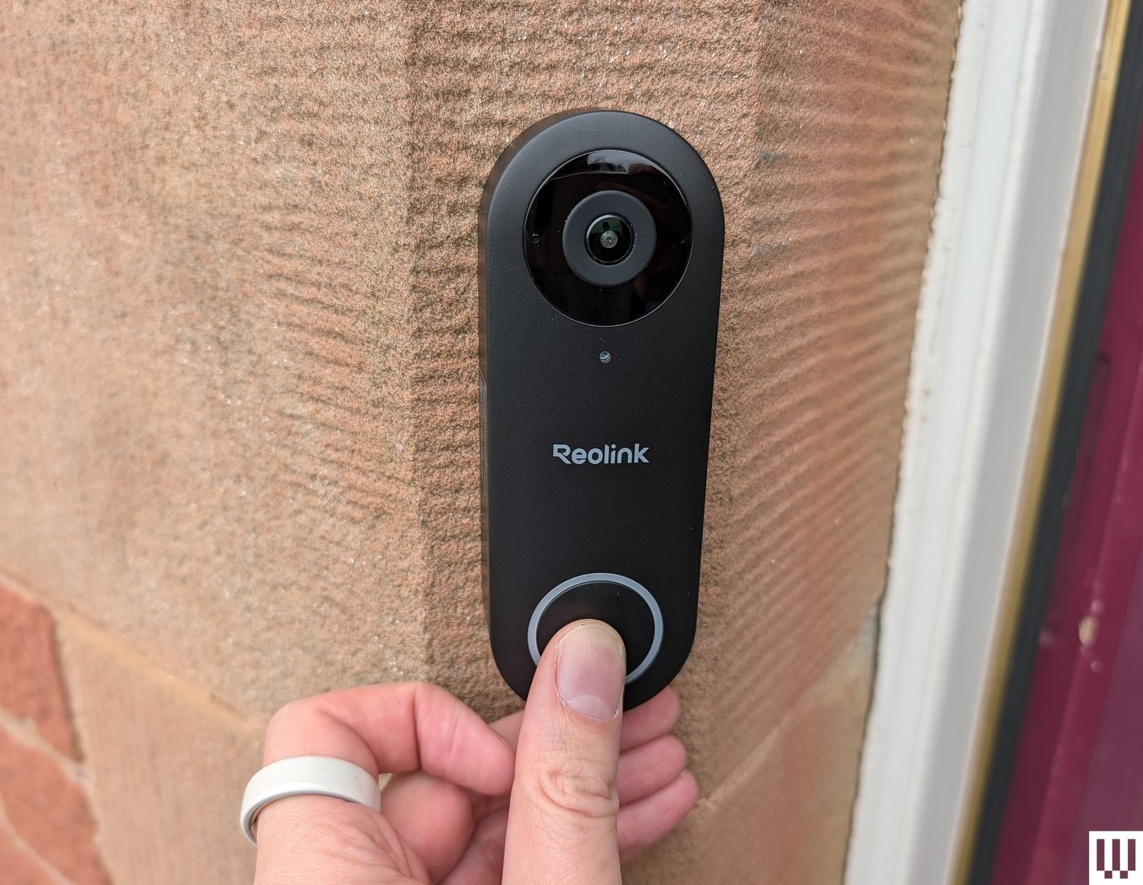 Reolink wireless black rectangular battery-powered electronic security camera attached outside house