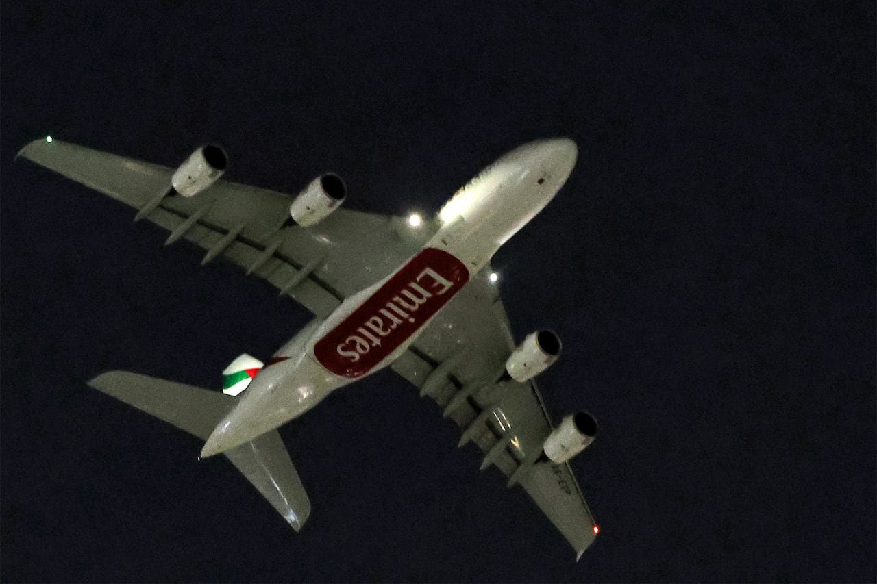 Emirates Airbus A380 taking off at night from Dubai International Airport