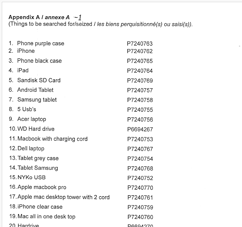 Law enforcement officers examining seized electronic devices