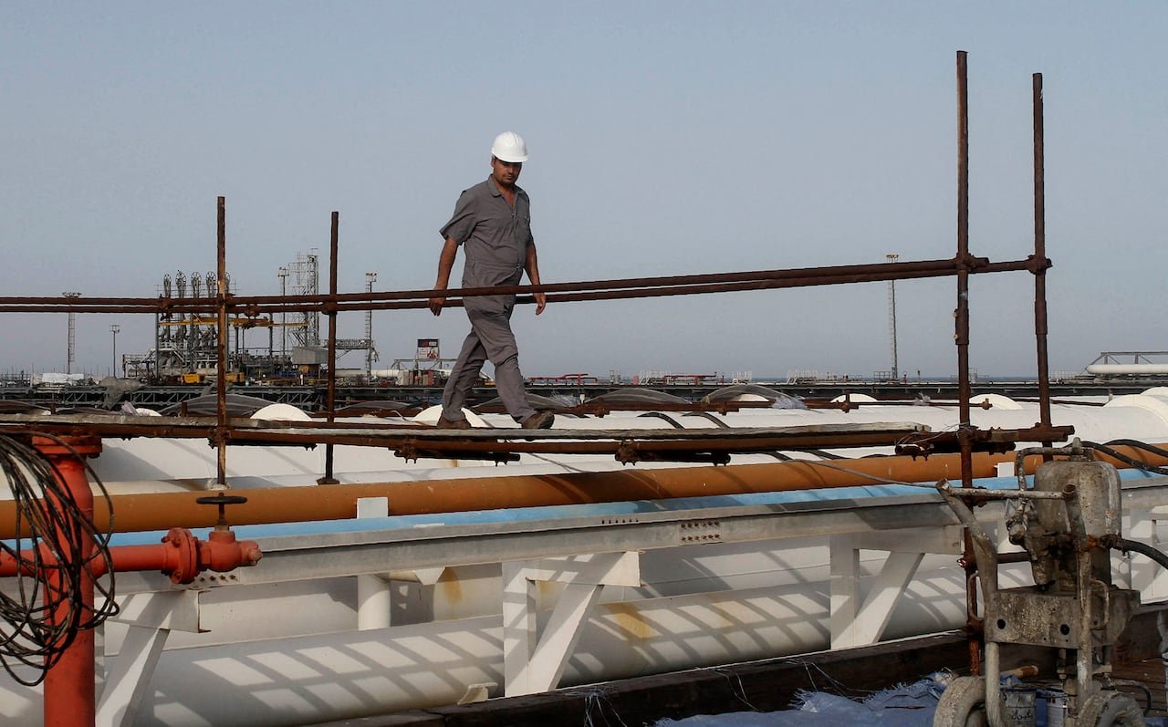 Oil worker atop pipelines at Khark Island facility