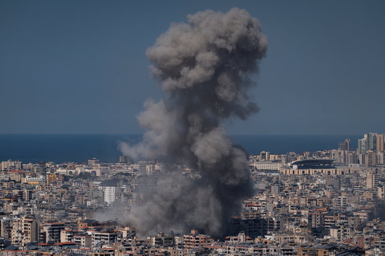 Smoke rising above buildings damaged during airstrikes