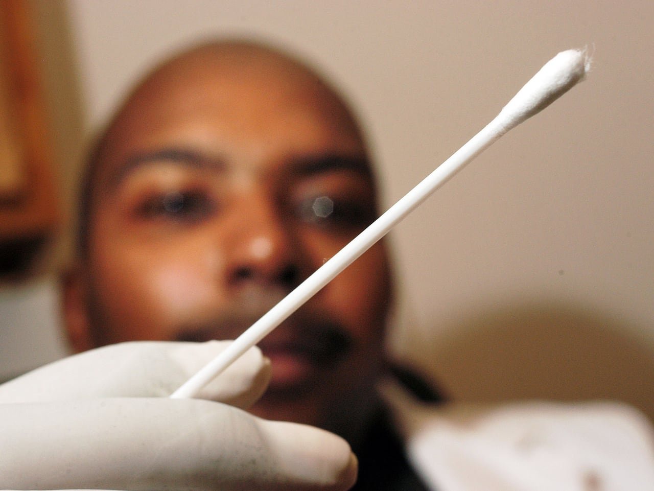 A person providing saliva sample for DNA testing