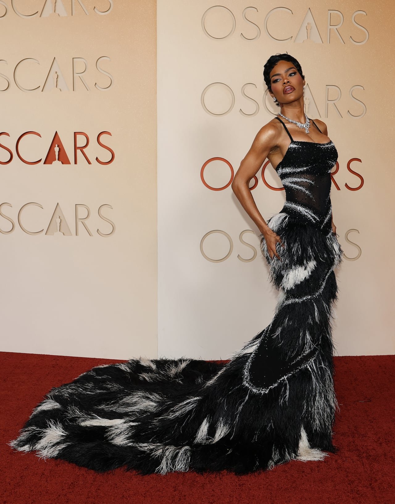 Teyana Taylor wearing a black-and-white beaded feathered gown with full train