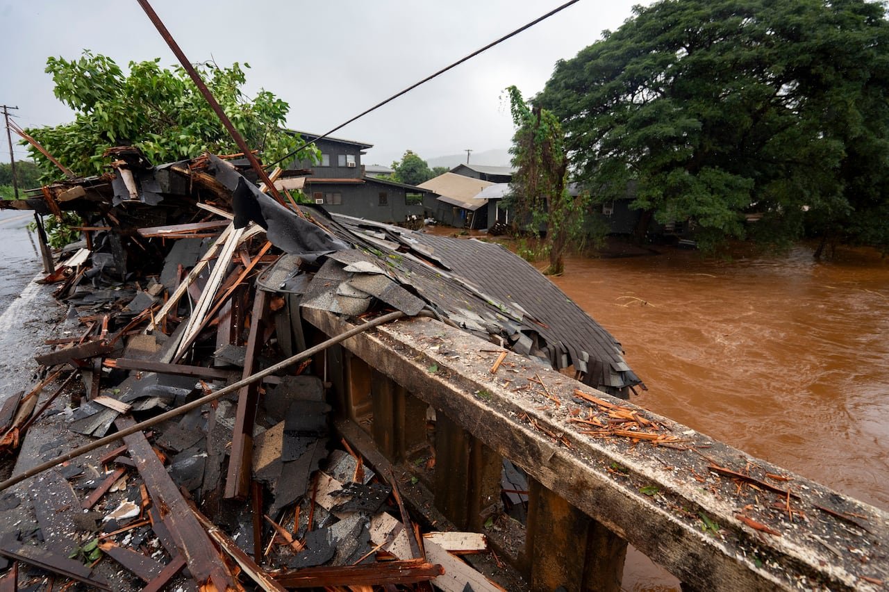 Storm debris piled against bridge after flooding