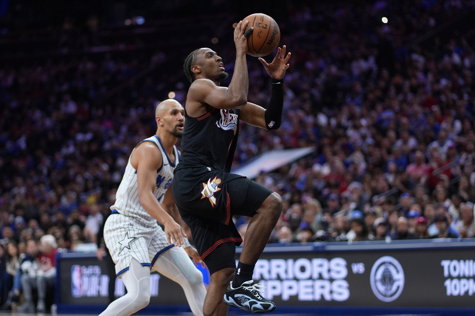 Tyrese maxey dribbling past defender