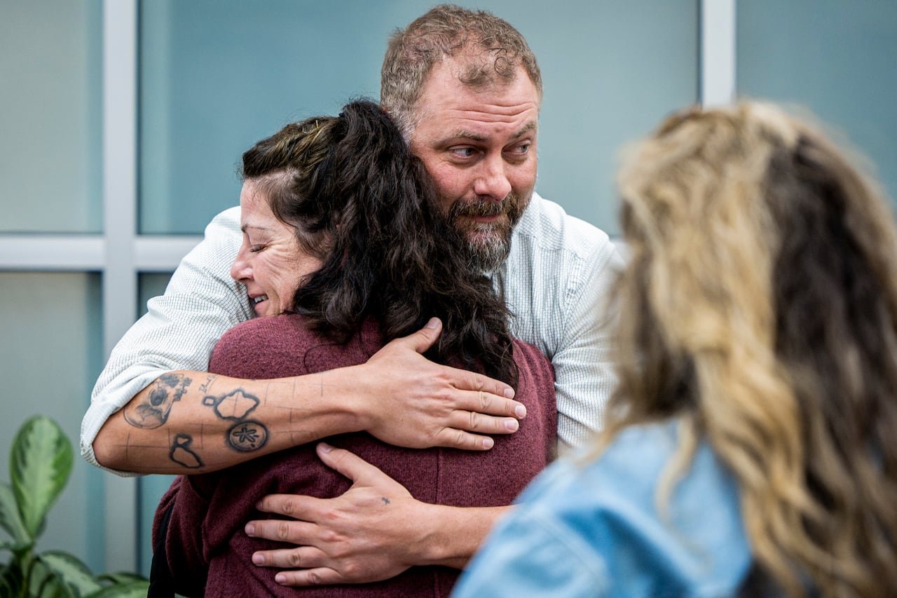 Detective comforting victim's family member