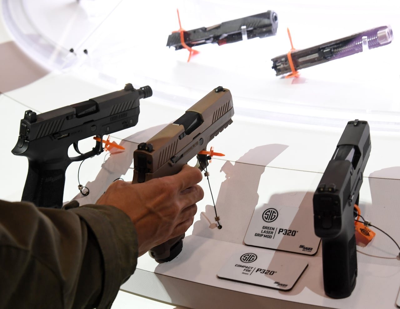 Three handguns displayed at trade show