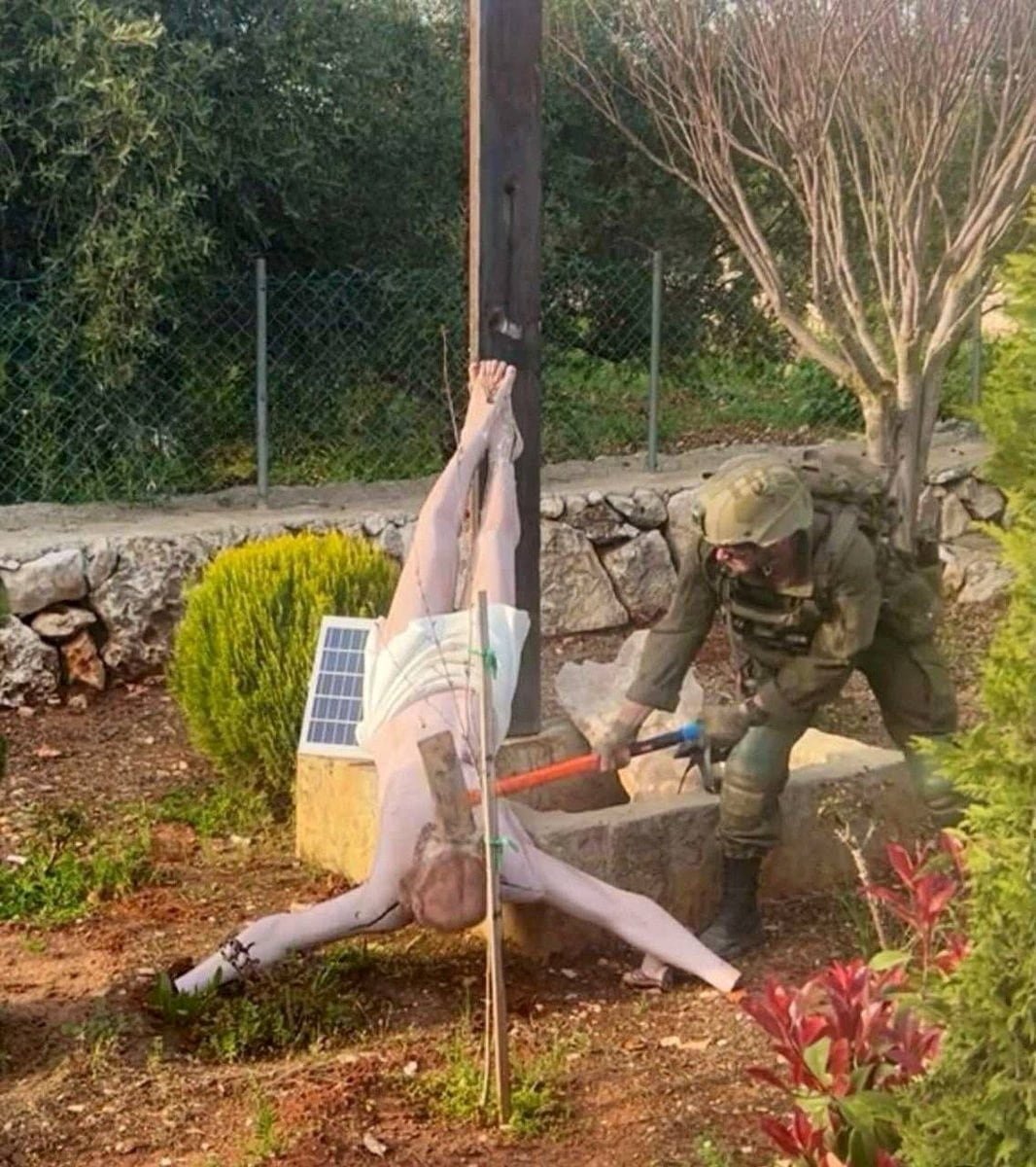 Israeli soldier damaging statue head