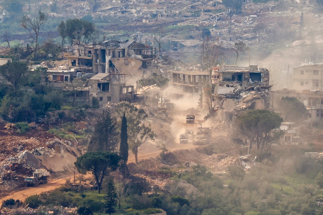 Military vehicles navigating war-torn roads