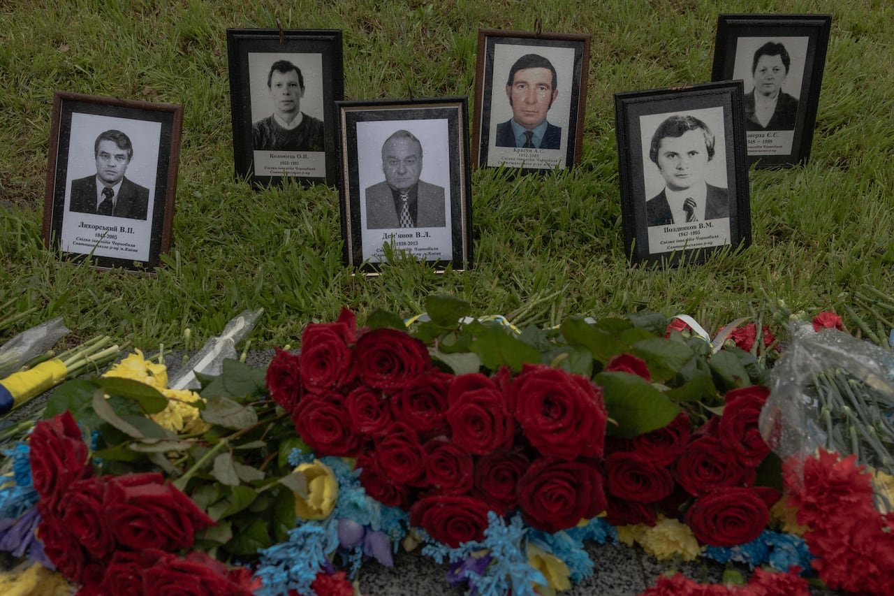 Memorial portraits surrounded by flowers honoring disaster victims