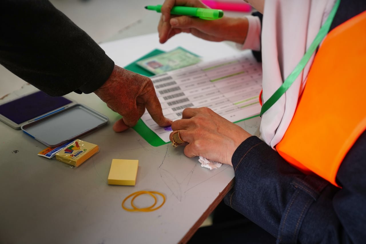 A voter stamping their fingerprint during election