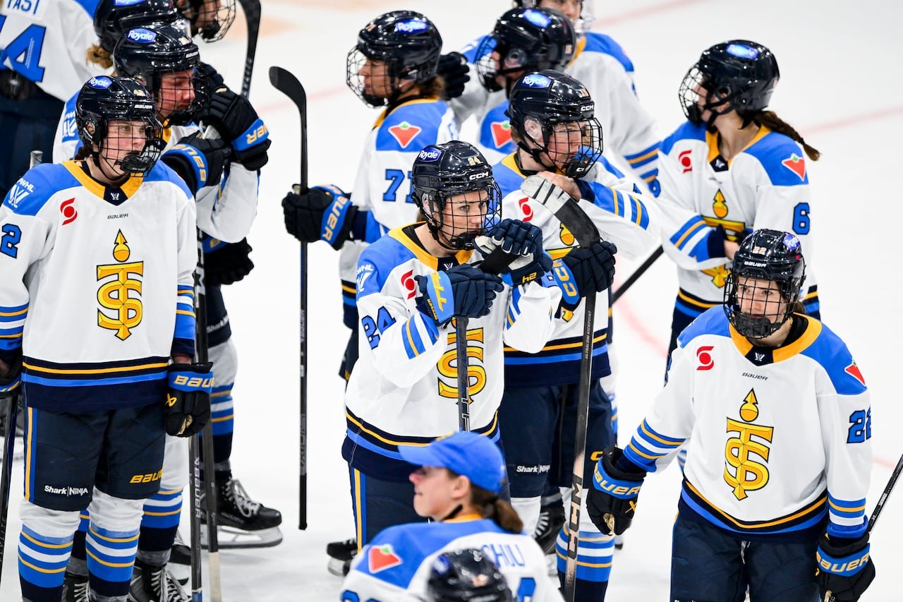 Hockey players look on after a loss.