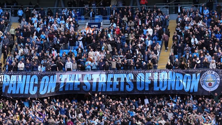 Manchester City displaying 'Panic on the Streets of London' banner after match