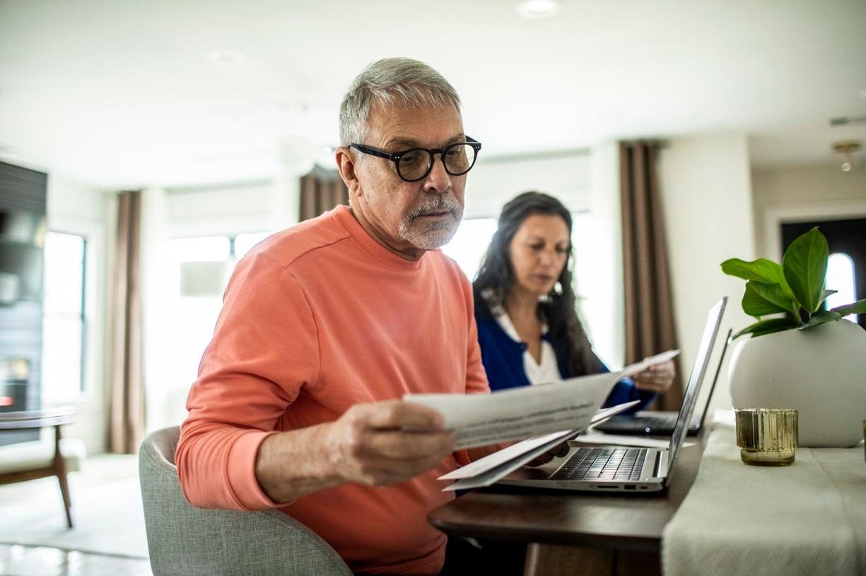 Elderly couple managing finances at home
