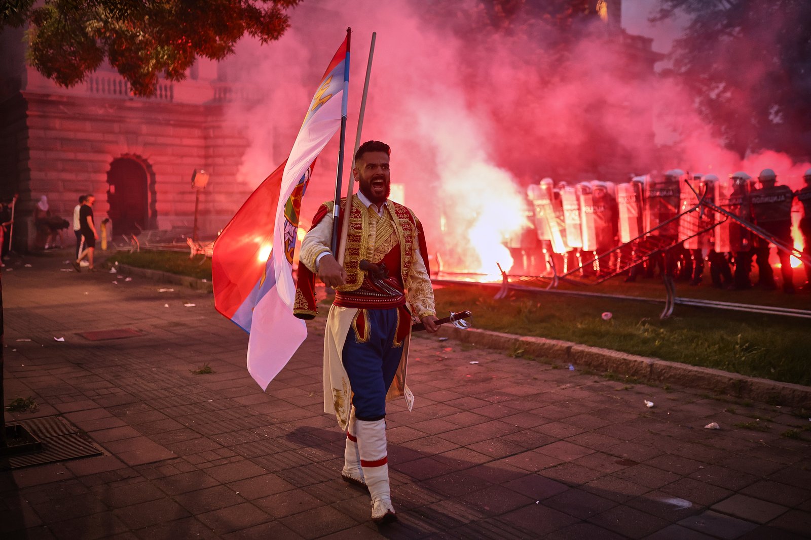 Serbian protester waving flag during demonstration