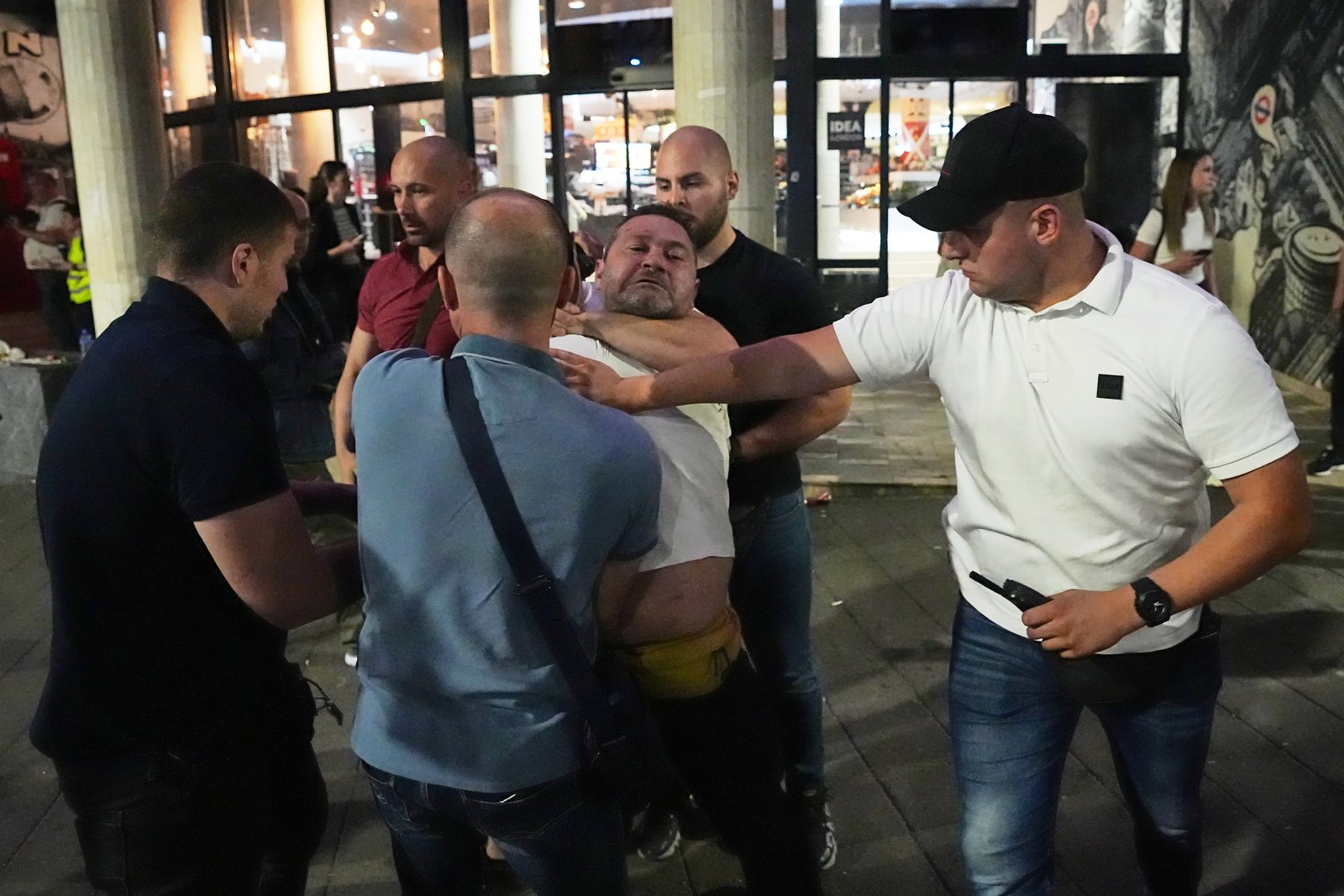 Plainclothes officers detaining protester 