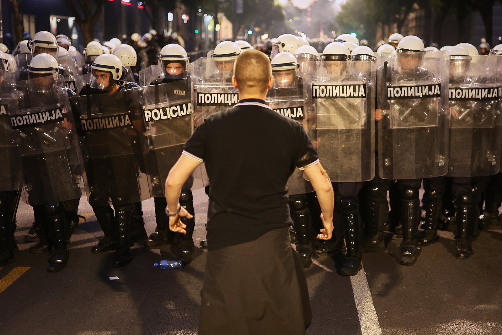 Protester confronting riot police in Belgrade