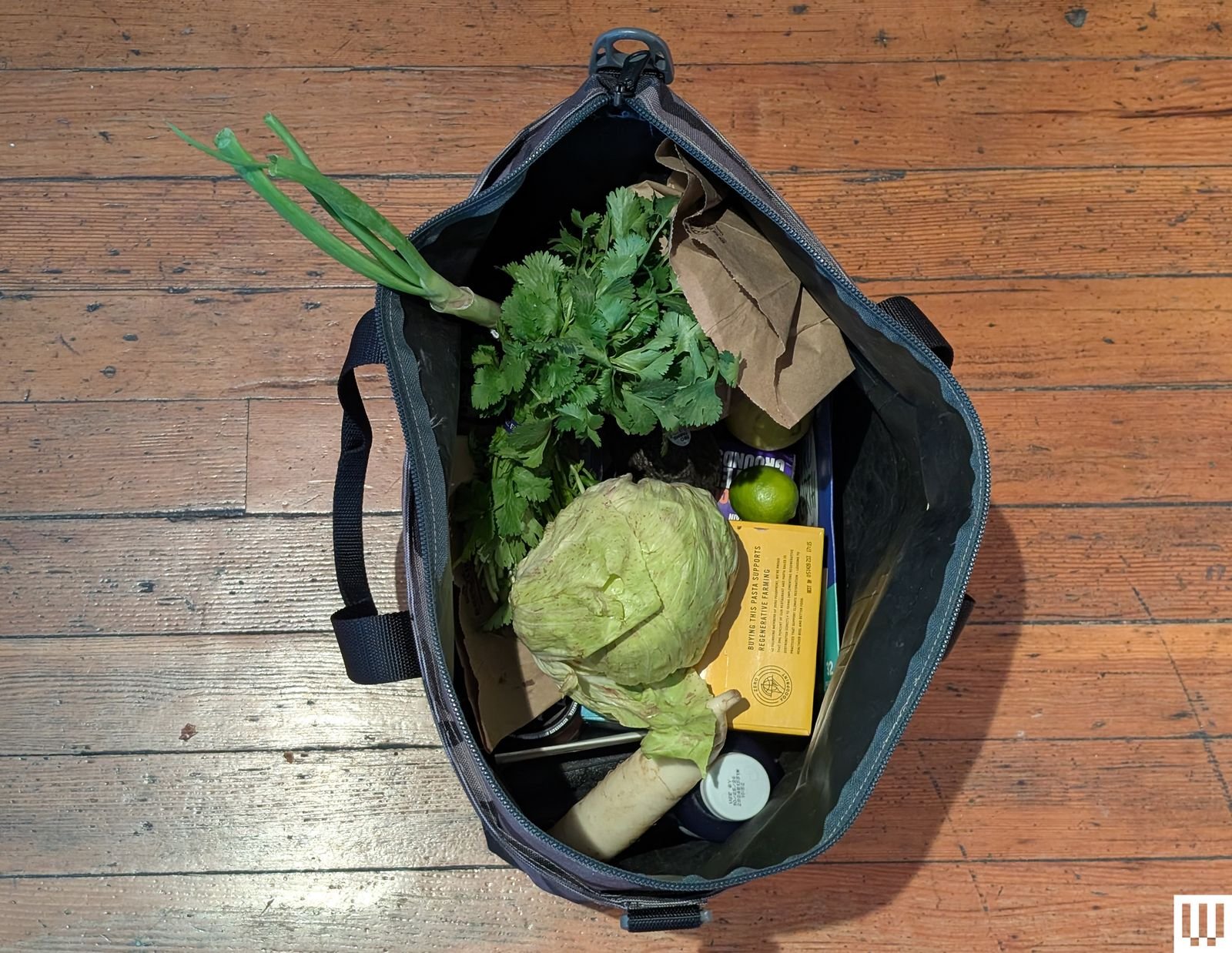 Overhead view of an open tote bag with fruits and vegetables inside