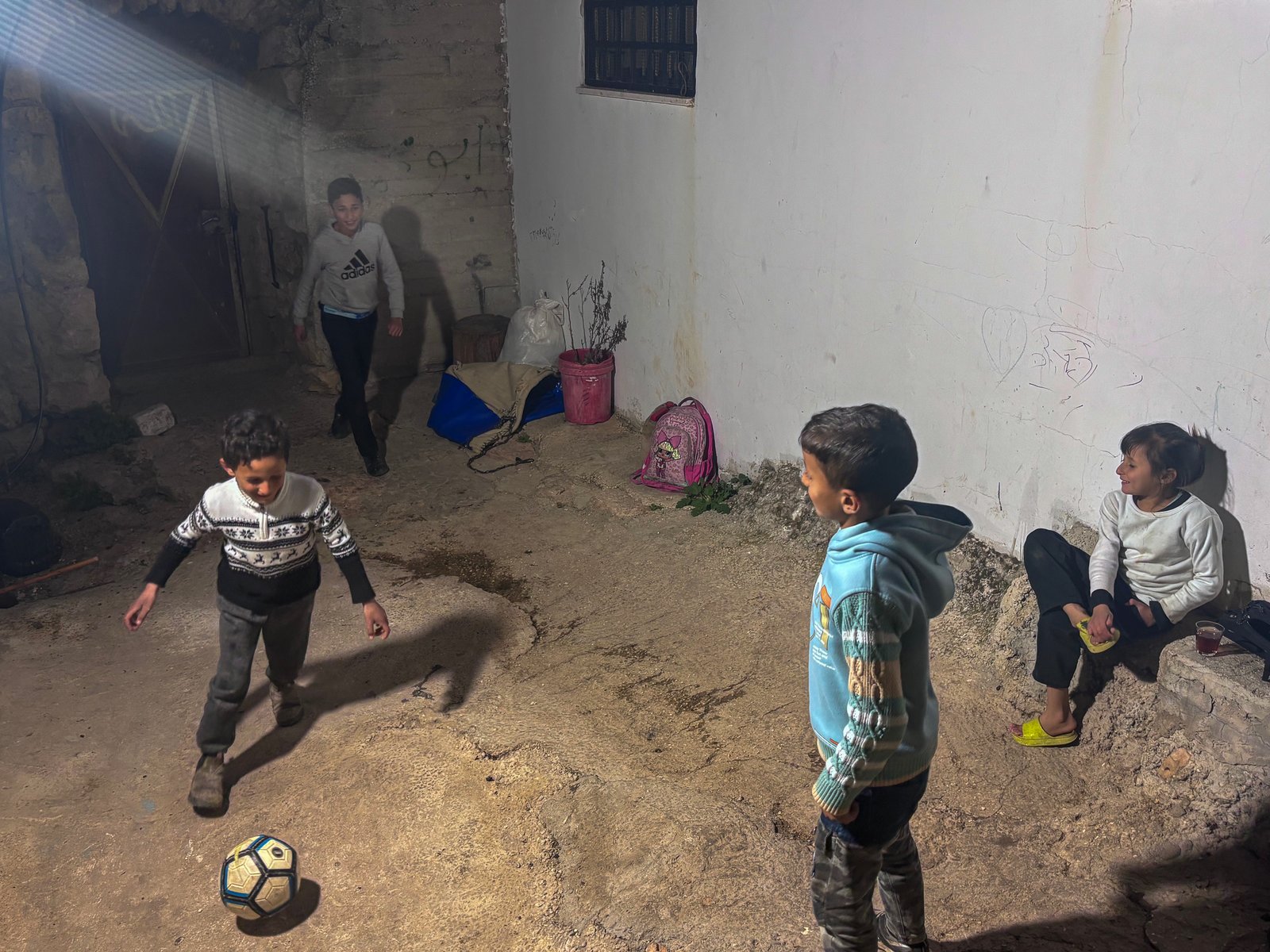 Children playing football inside compound