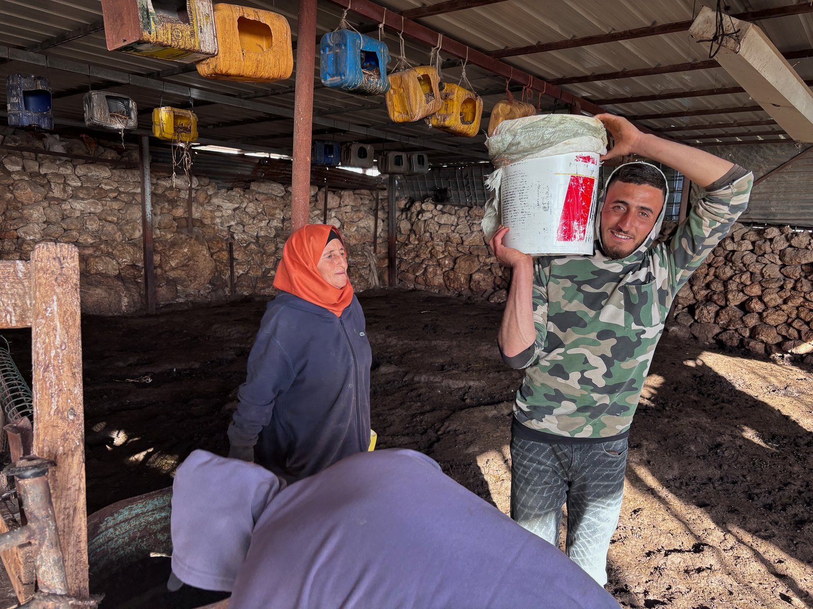 Family members carry fresh milk buckets